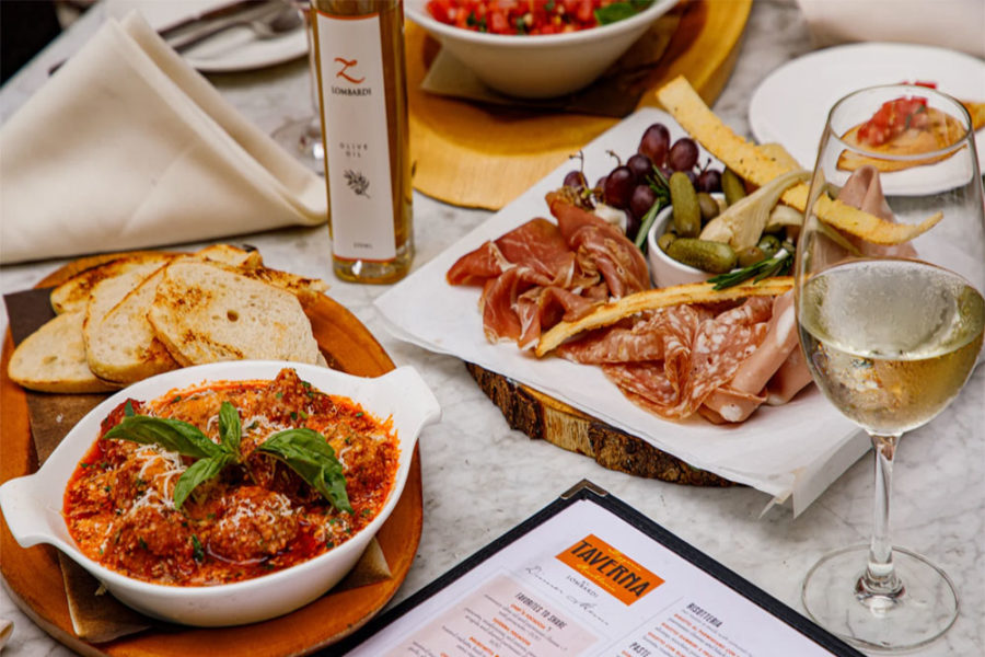 charcuterie plate, meatballs, fresh bread, and a glass of wine from taverna in dallas