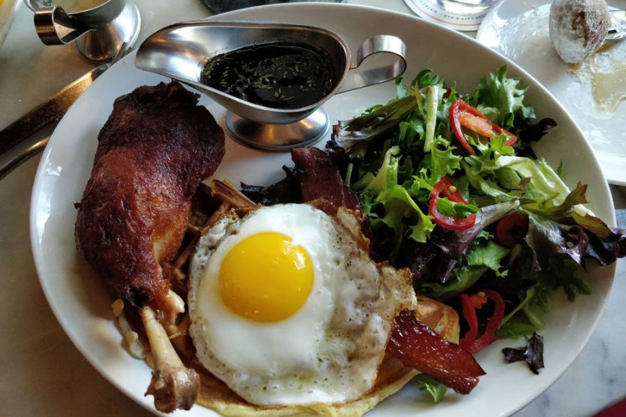 breakfast plate with chicken, egg, and salad from toulouse cafe in dallas