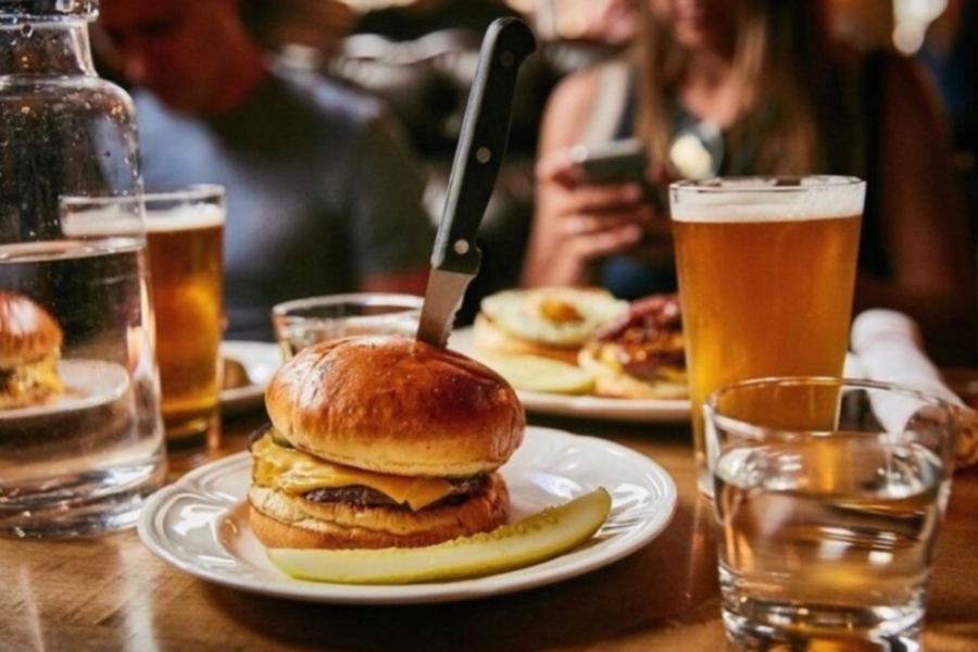 cheeseburger and a cold glass of beer from au cheval in chicago