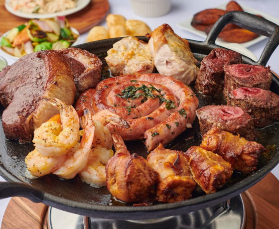 meat platter with pork chops, shrimp, chicken, sausage, and steak from brazz carvery brazilian steakhouse in charlotte