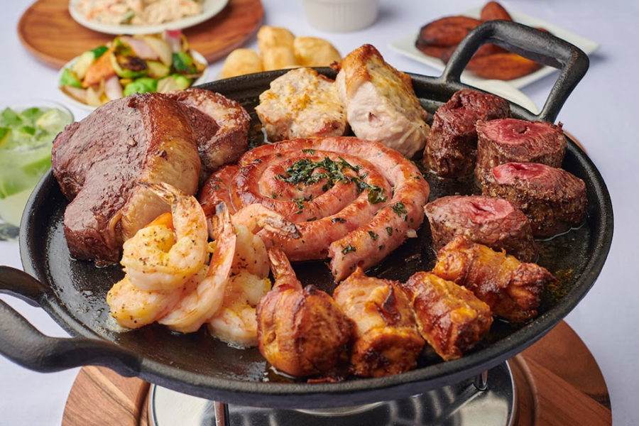 meat platter with pork chops, shrimp, chicken, sausage, and steak from brazz carvery brazilian steakhouse in charlotte
