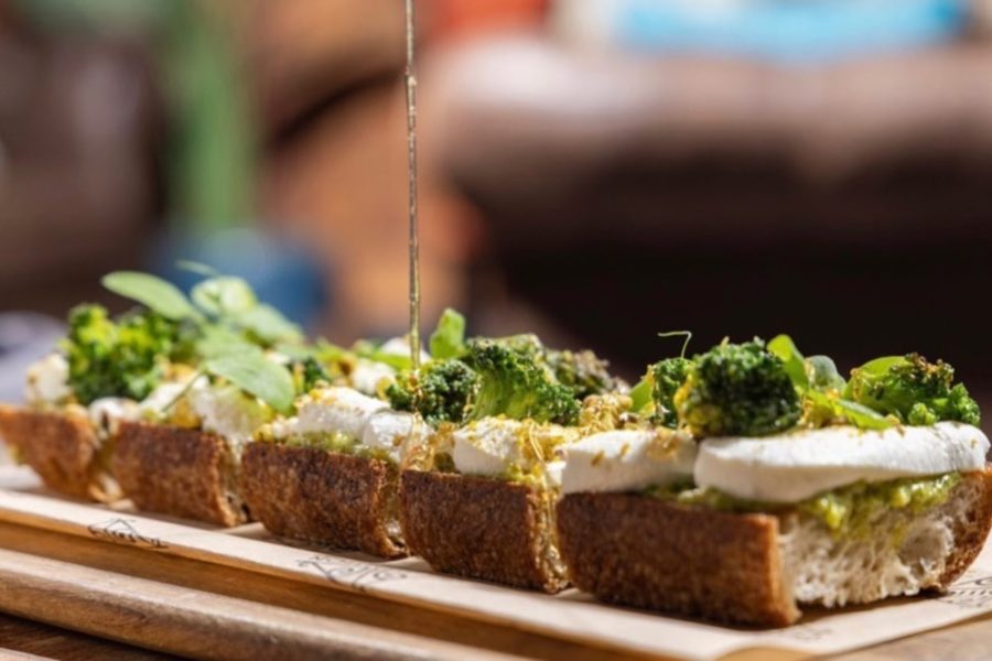 toast topped with avocado, burrata, and greens from prohibition in charleston