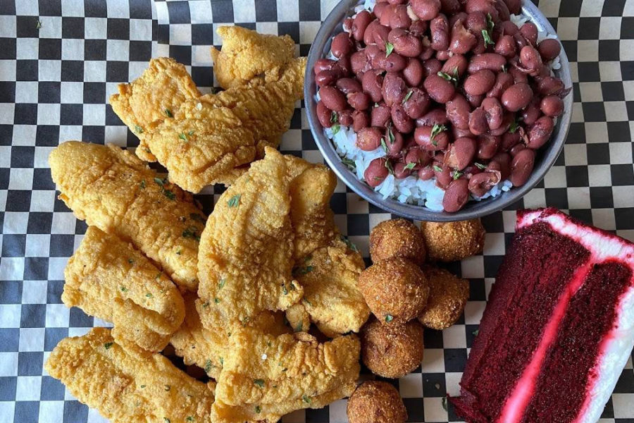 fried fish, hushpuppies, rice with beans, and a slice of red velvet cake from soul in seattle