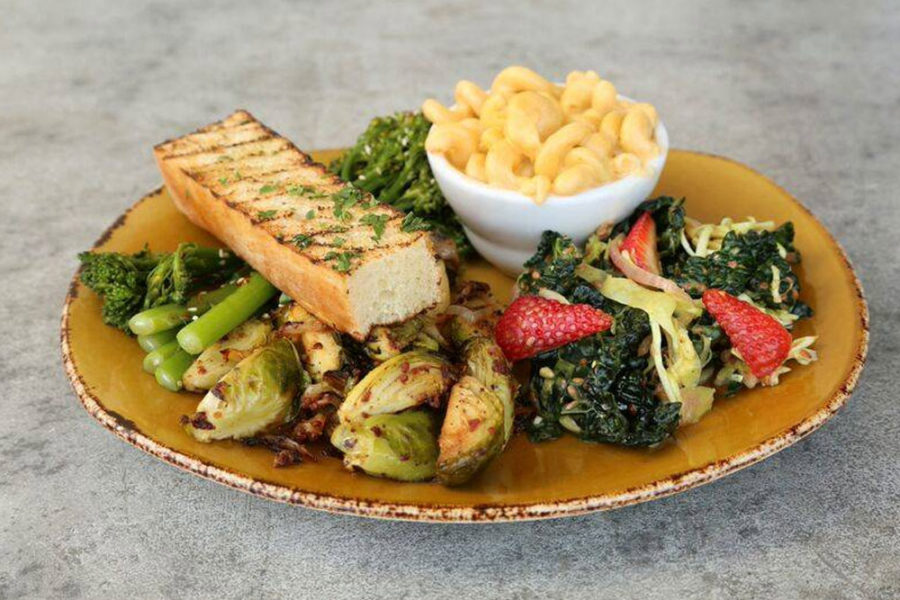 strawberry salad with kale, brussel sprouts, asparagus, toasted bread, and a side of mac and cheese from urban plates in san diego