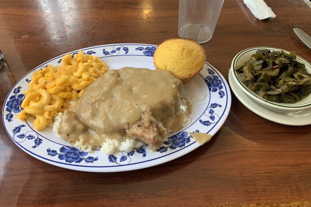 gravy porkchops with side of mac and cheese, cornbread, and collard greens from CoraFaye's Cafe in Denver