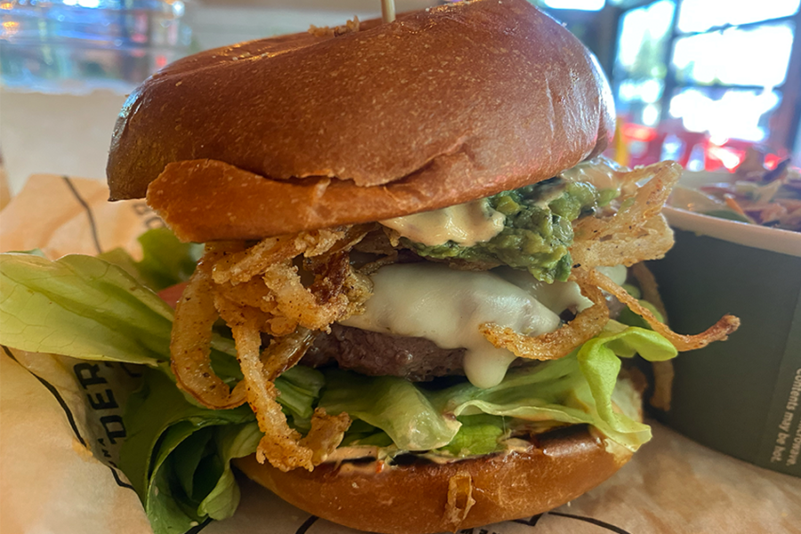 Downtowner Burger with fire-roasted corn guacamole, pepper jack, crispy onion strings, L, T, and chipotle ranch from Arizona Wilderness Brewing Company in Phoenix, Arizona