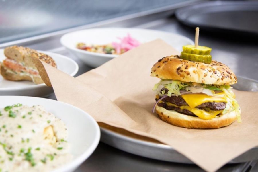 A burger with pickles from Against the Grain