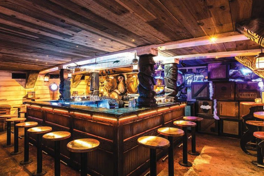 The interior of the Killer Whale Sex Club. The decorations are tiki-themed.