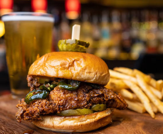 A fried chicken sandwich, fries, and a beer from Louie's Pub