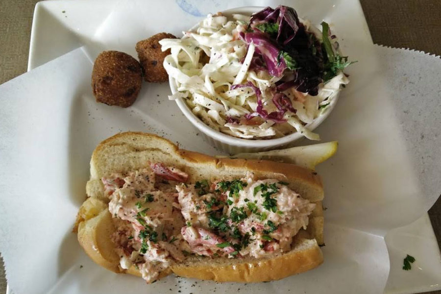 A lobster roll, coleslaw and hush puppies from Sea Breeze Fish Market