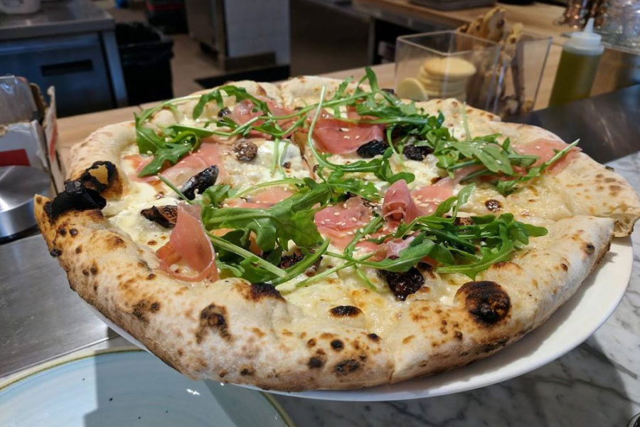 A cheese, arugula, and prosciutto pizza from Sixty-Vines