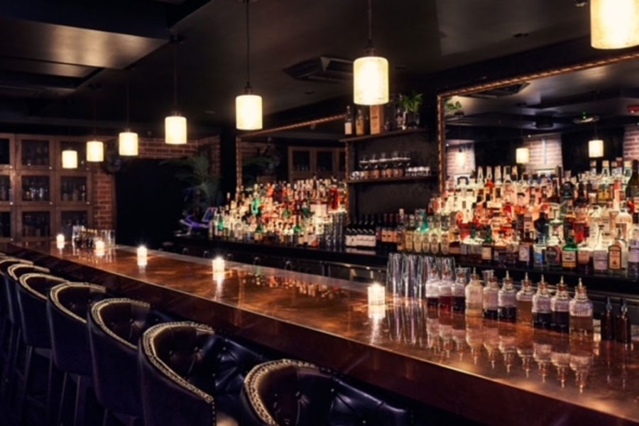 The interior of a bar with bottles at Stardust Pinbar