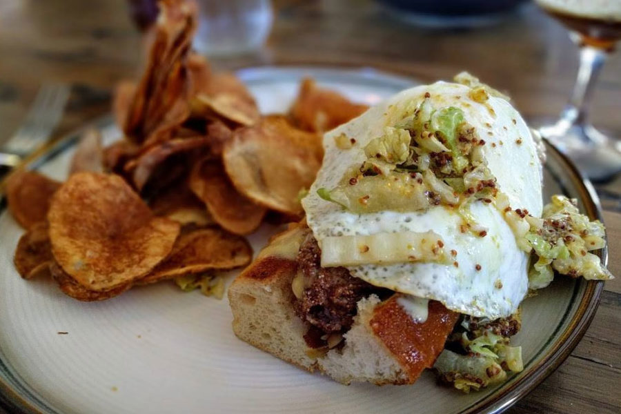 A beef sandwich with egg and chips from Harold's Cabin