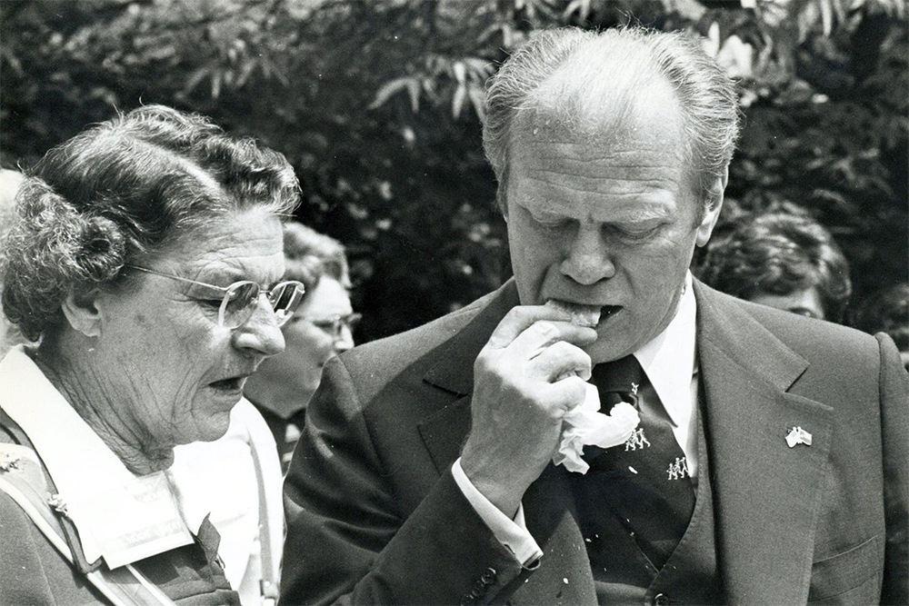 Gerald Ford biting into a tamale with the husk on