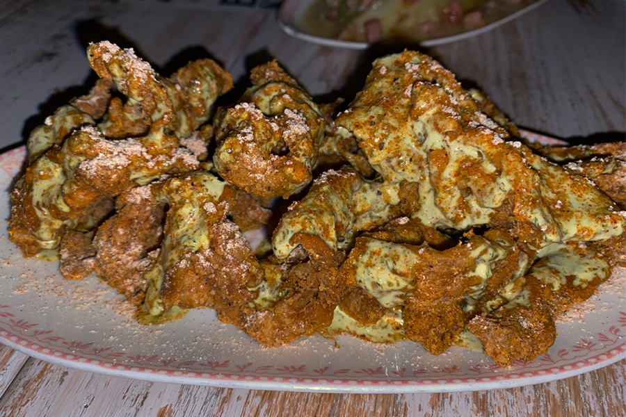 Fried chicken skins covered in a green ranch sauce