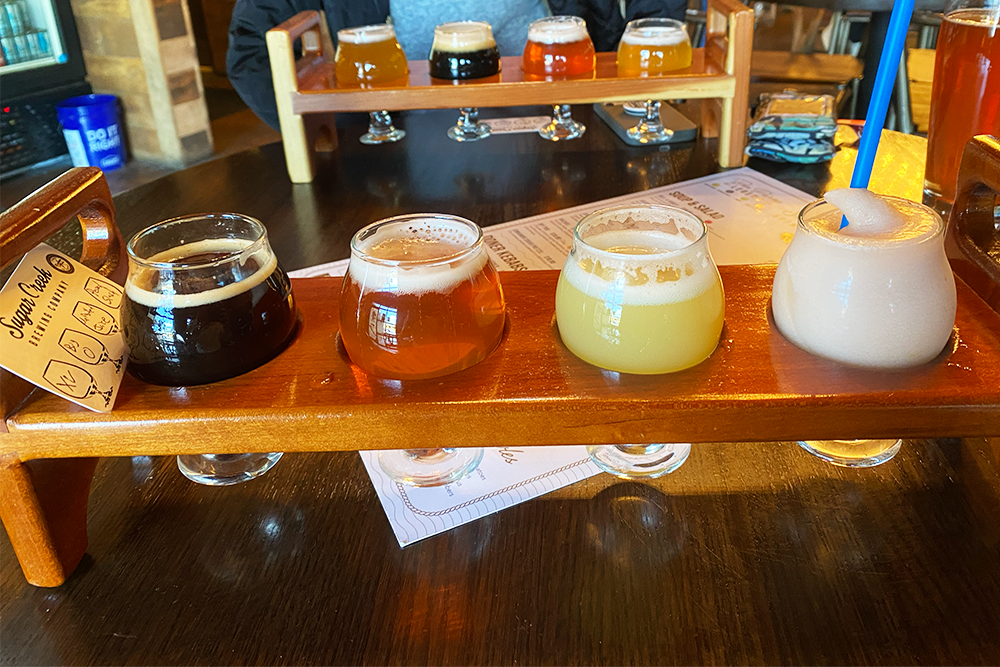 Flight of four drinks of varying colors and hues