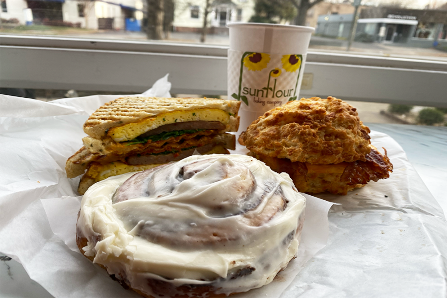 Cinnamon bun, two different sandwiches, and cup of coffee