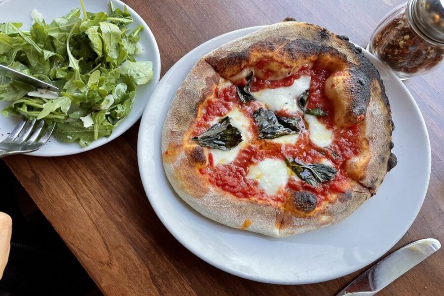 pizza and side salad from mioposto in Seattle