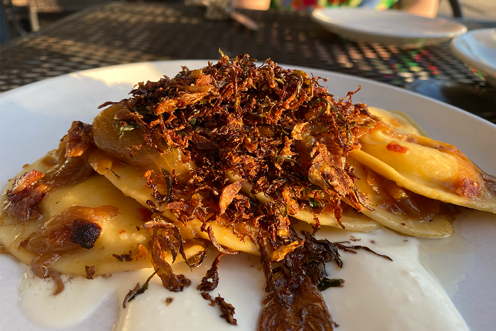Pierogies on a plate with crispy onions on top