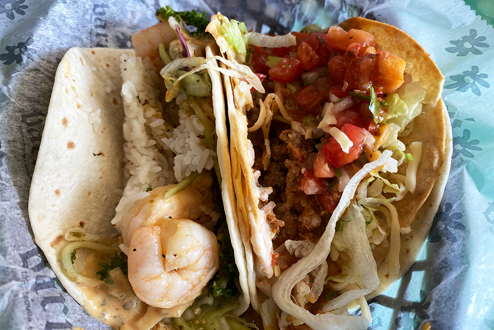 Two tacos, one with shrimp and the other with beef