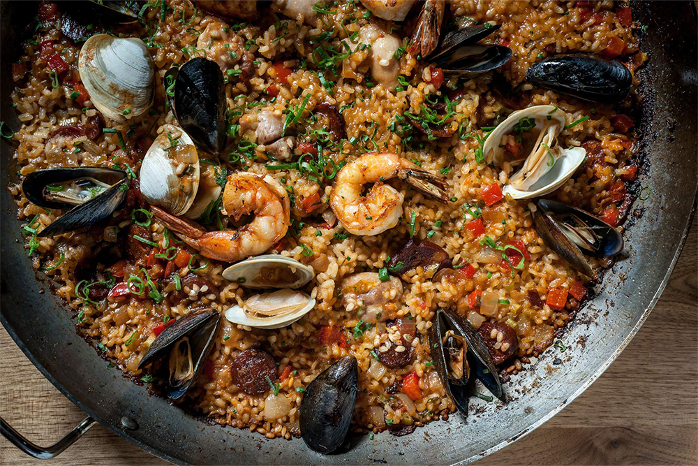 Bowl of paella with shrimp, mussels, clams, and more